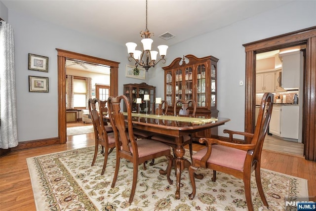 38 Arlington Ave, Hawthorne, NJ 07506 - dining room with a chandelier, light wood-style floors, and baseboards