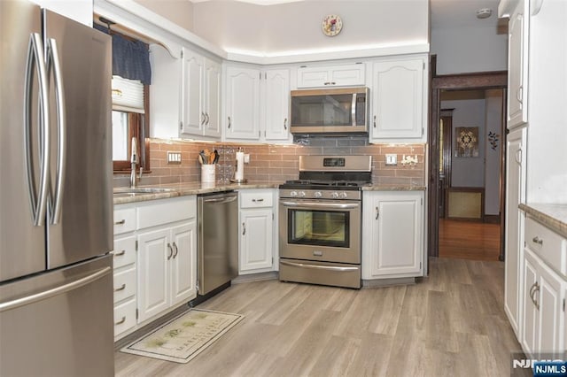 38 Arlington Ave, Hawthorne, NJ 07506 - kitchen featuring appliances with stainless steel finishes, a sink, white cabinetry, and light wood-type flooring