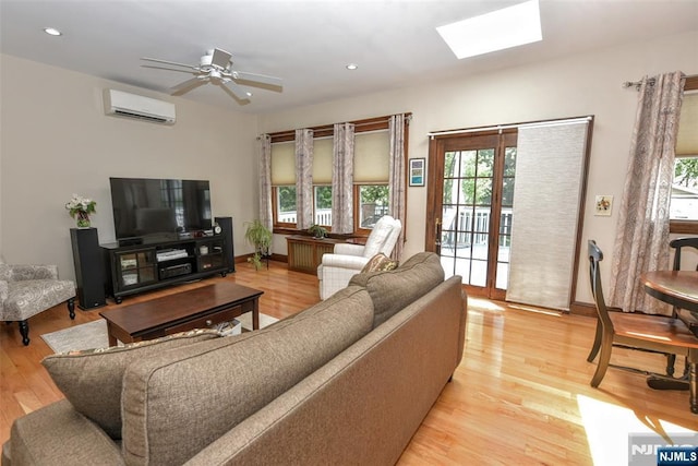 38 Arlington Ave, Hawthorne, NJ 07506 - living room with an AC wall unit, healthy amount of natural light, a skylight, light wood-style flooring, and recessed lighting