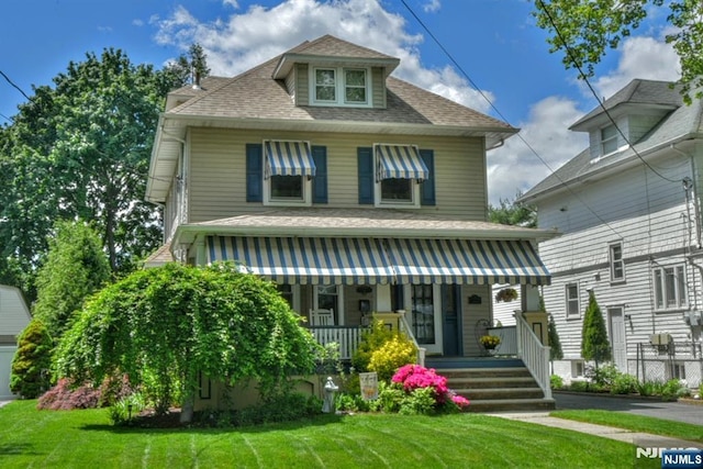 38 Arlington Ave, Hawthorne, NJ 07506 - american foursquare style home featuring a porch, a front yard, and roof with shingles