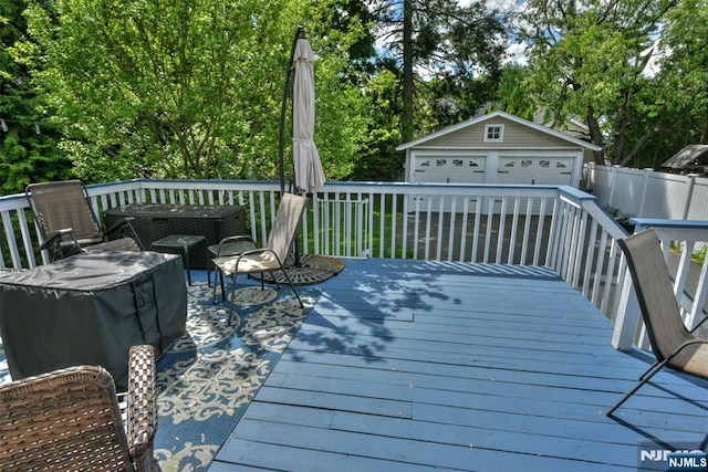 38 Arlington Ave, Hawthorne, NJ 07506 - wooden terrace with an outdoor structure, a detached garage, and view of wooded area