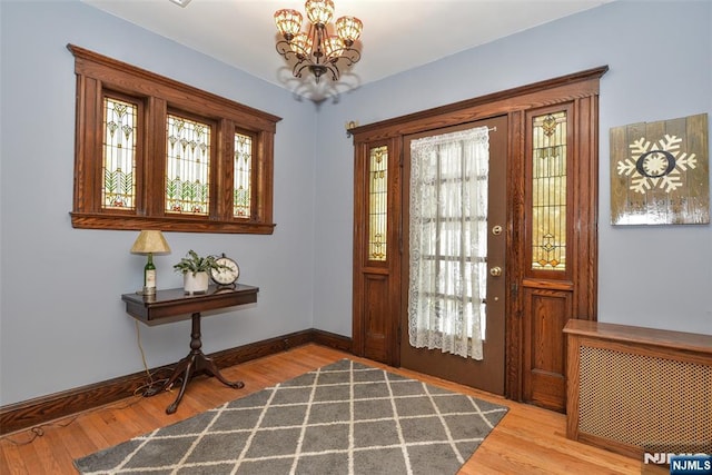 38 Arlington Ave, Hawthorne, NJ 07506 - foyer featuring a chandelier, baseboards, and wood finished floors