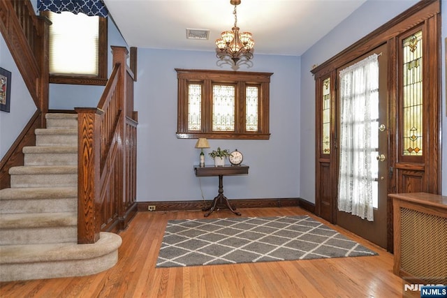 38 Arlington Ave, Hawthorne, NJ 07506 - entryway featuring stairs, a chandelier, wood finished floors, and baseboards