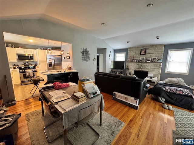 717 1st St, Lyndhurst, NJ 07071 - living room featuring lofted ceiling, light wood finished floors, and a fireplace