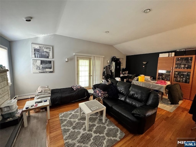 717 1st St, Lyndhurst, NJ 07071 - living area with vaulted ceiling, plenty of natural light, baseboard heating, and wood finished floors
