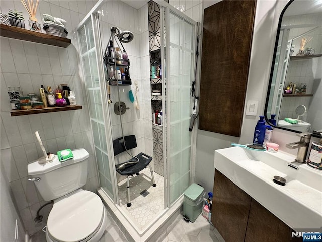 717 1st St, Lyndhurst, NJ 07071 - bathroom featuring tile walls, toilet, a shower stall, tile patterned flooring, and vanity