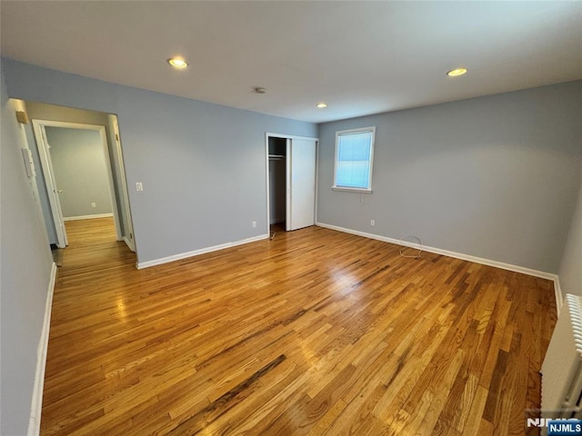 717 1st St, Lyndhurst, NJ 07071 - unfurnished bedroom featuring light wood-style floors, baseboards, recessed lighting, and a closet