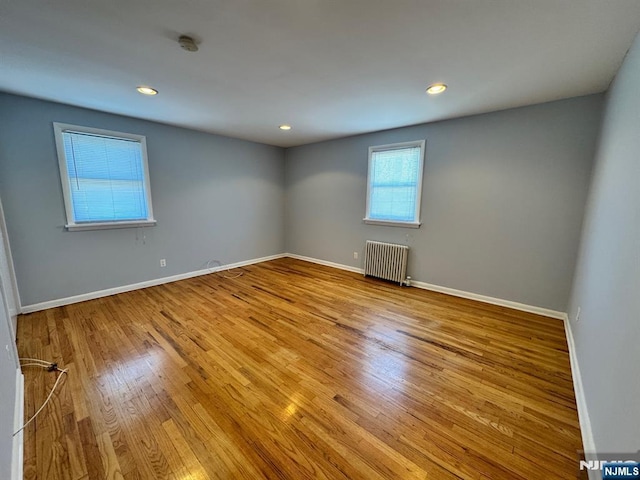 717 1st St, Lyndhurst, NJ 07071 - empty room featuring radiator heating unit, wood finished floors, a smoke detector, baseboards, and recessed lighting