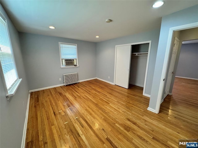 717 1st St, Lyndhurst, NJ 07071 - unfurnished bedroom featuring radiator, light wood-style floors, recessed lighting, baseboards, and cooling unit