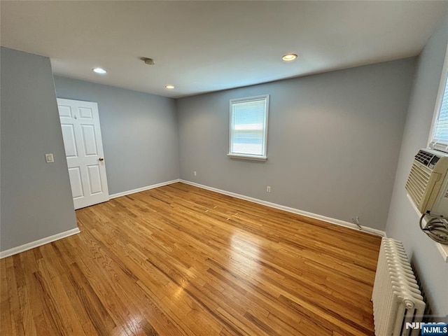 717 1st St, Lyndhurst, NJ 07071 - spare room with radiator heating unit, baseboards, light wood-style floors, and recessed lighting