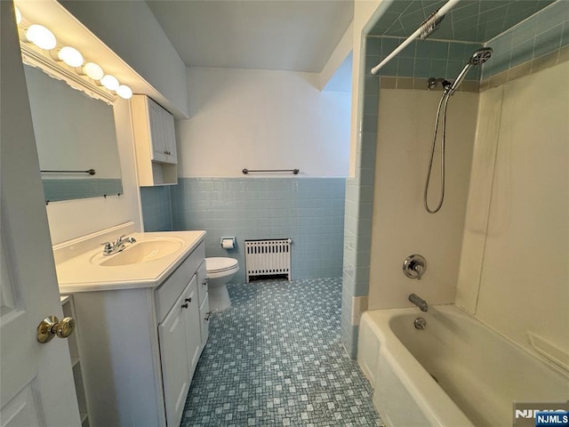 717 1st St, Lyndhurst, NJ 07071 - bathroom with radiator, toilet, vanity, shower / tub combination, and tile walls
