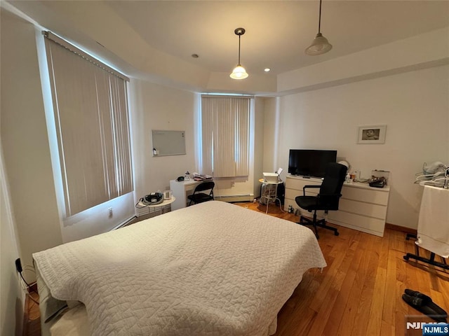 717 1st St, Lyndhurst, NJ 07071 - bedroom with light wood-type flooring, baseboard heating, a desk, and baseboards