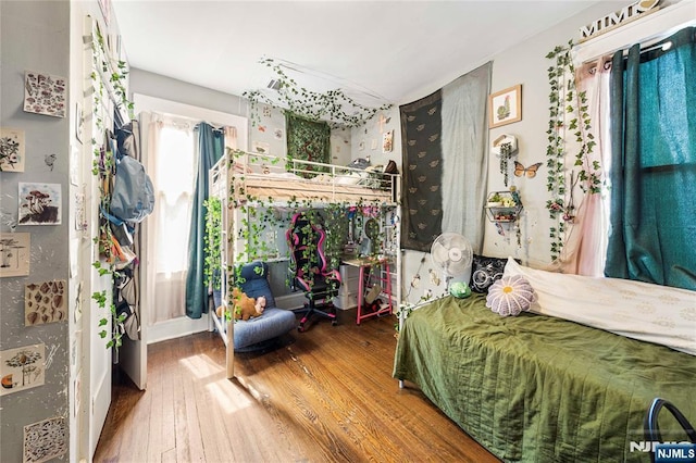 bedroom with hardwood / wood-style flooring