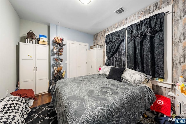 bedroom with dark wood finished floors