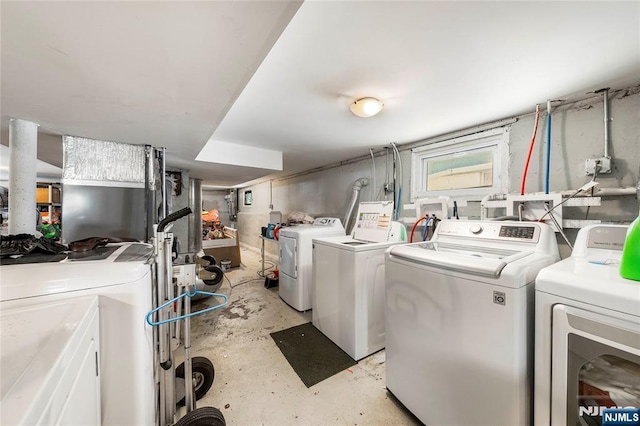 clothes washing area with independent washer and dryer
