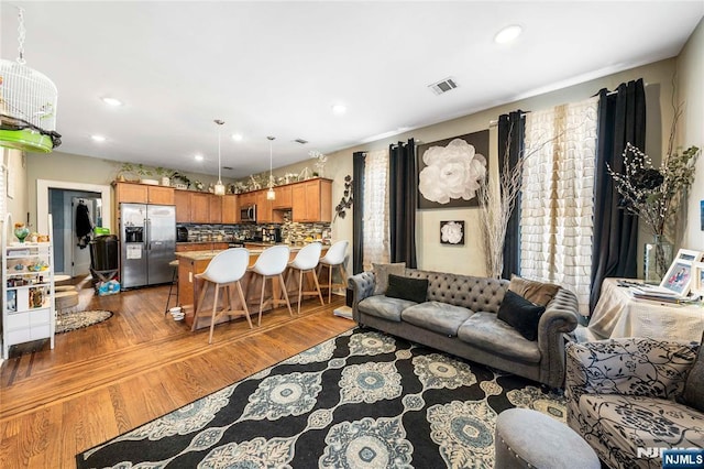 living room featuring recessed lighting and wood finished floors