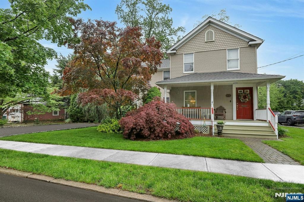 412 Northern Pkwy, Ridgewood, NJ 07450 - victorian-style house with covered porch and a front lawn