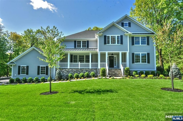 view of front of home featuring a front lawn, a porch, and stone siding