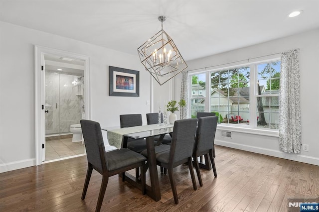 dining space with a chandelier, wood-type flooring, baseboards, and recessed lighting