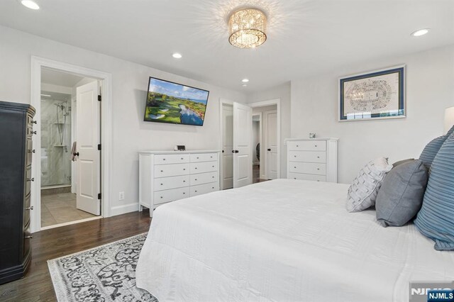 bedroom with dark wood-style floors, recessed lighting, baseboards, and ensuite bathroom