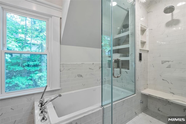 bathroom featuring a shower stall and a bath