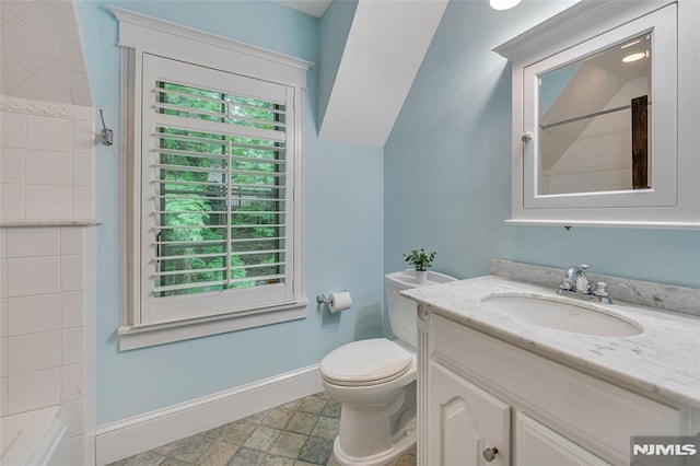 full bath with baseboards, toilet, vanity, and a shower
