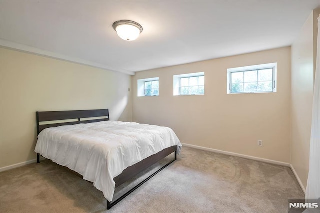 bedroom featuring carpet flooring and baseboards