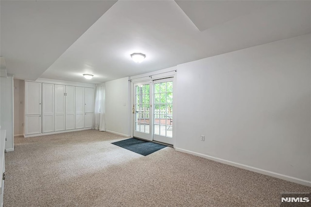 unfurnished room featuring carpet floors and baseboards