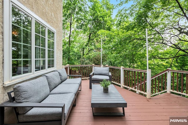 wooden terrace with an outdoor hangout area