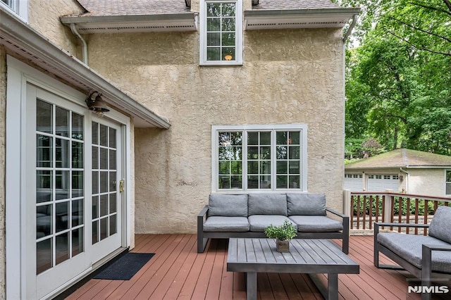 deck featuring an outdoor hangout area and an outdoor structure