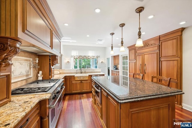 15 Hamilton Rd, Morristown Town, NJ 07960 - kitchen featuring high end range, brown cabinets, decorative backsplash, a peninsula, and dark wood-style flooring