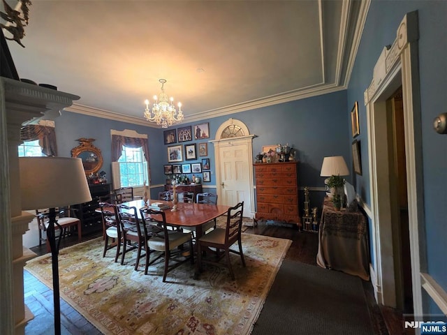 dining space featuring a chandelier, crown molding, and dark wood-type flooring
