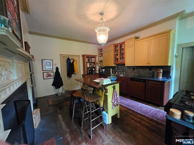 kitchen with dark countertops, a fireplace, decorative backsplash, crown molding, and dark wood finished floors