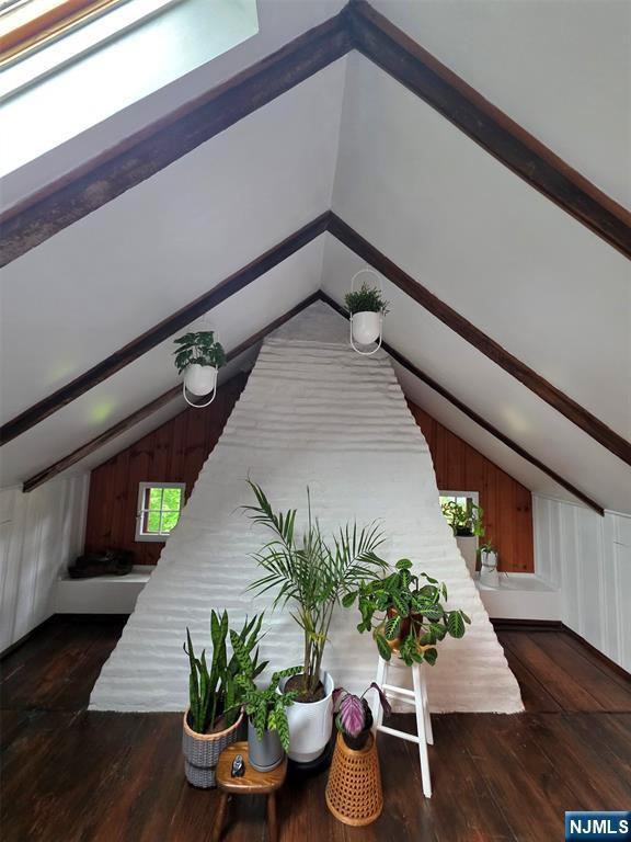 detailed view of wood finished floors and beam ceiling