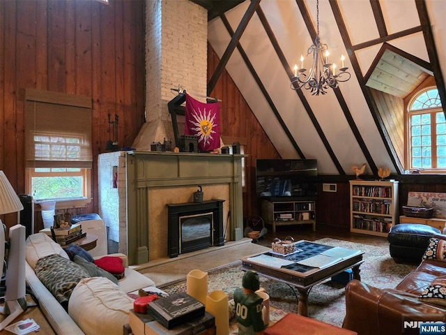 living room featuring wooden walls, a chandelier, high vaulted ceiling, beamed ceiling, and a premium fireplace