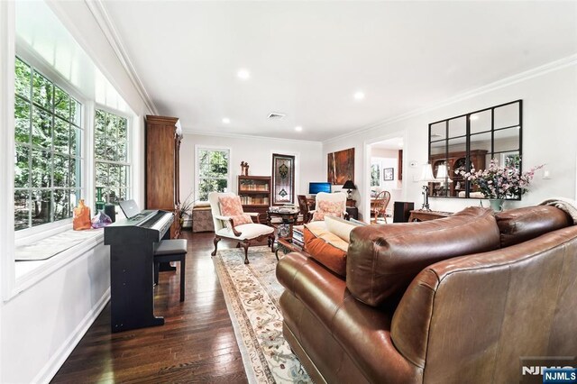 living room featuring crown molding, dark wood-type flooring, and recessed lighting