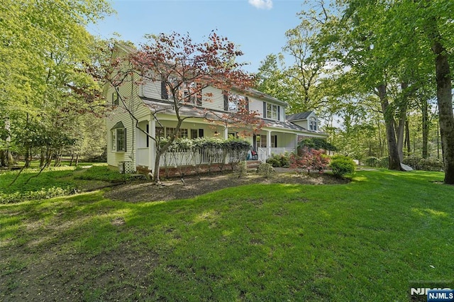 view of front facade with covered porch and a front lawn