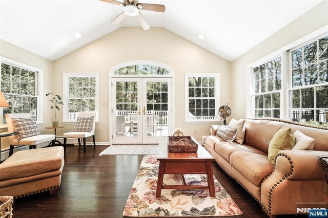 living room featuring lofted ceiling, dark wood-style flooring, plenty of natural light, french doors, and a ceiling fan