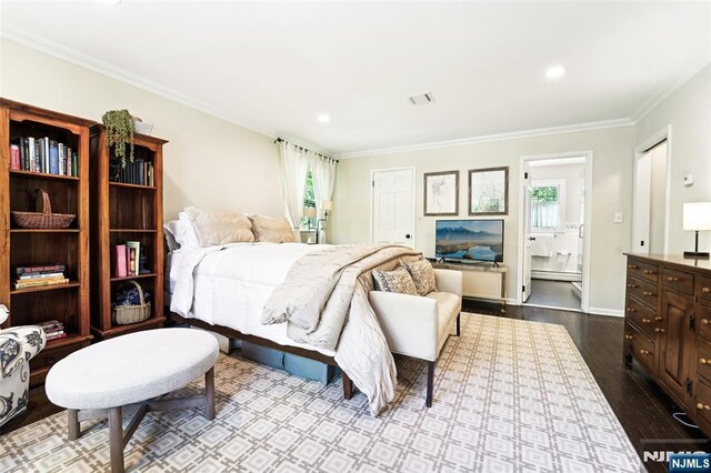 bedroom featuring crown molding, dark wood-type flooring, ensuite bath, recessed lighting, and baseboards