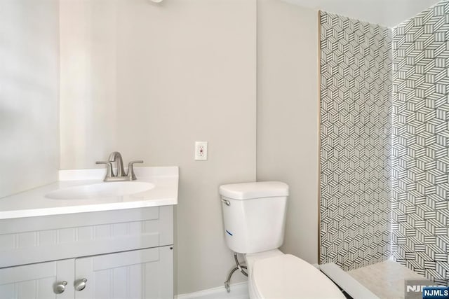 14 Harvard Ave, Wyckoff, NJ 07481 - full bath featuring toilet, a tile shower, vanity, and baseboards