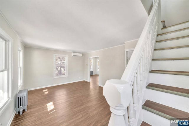 14 Harvard Ave, Wyckoff, NJ 07481 - stairs featuring radiator, an AC wall unit, crown molding, wood finished floors, and baseboards