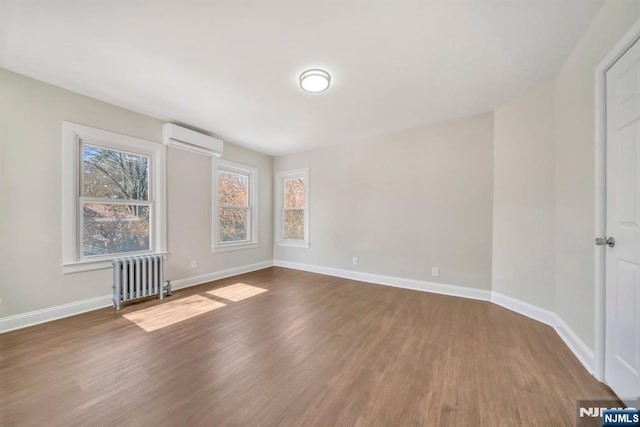 14 Harvard Ave, Wyckoff, NJ 07481 - spare room featuring radiator heating unit, a wall unit AC, wood finished floors, and baseboards