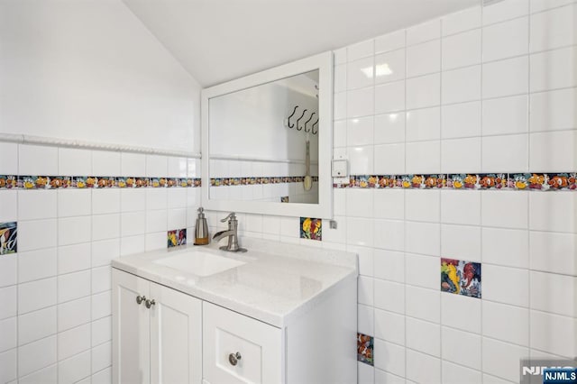 bathroom featuring tile walls and vanity