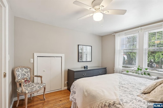 bedroom featuring light wood finished floors and a ceiling fan