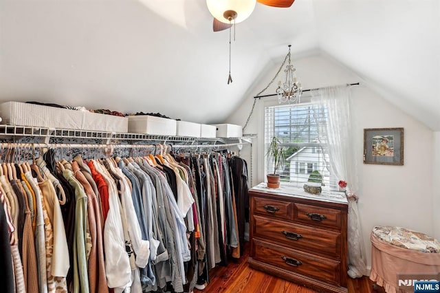 spacious closet with wood finished floors, vaulted ceiling, and a ceiling fan