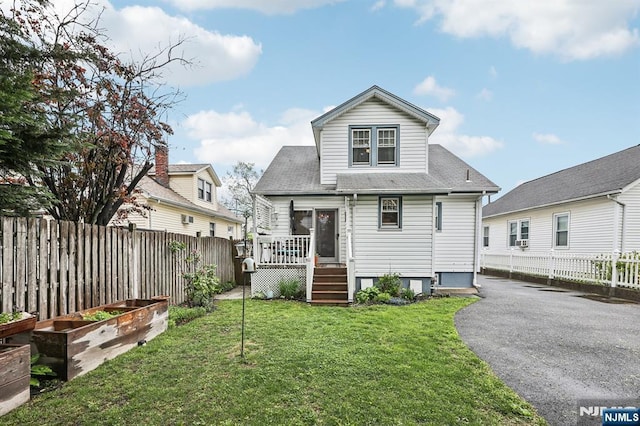 rear view of house with a garden and a deck