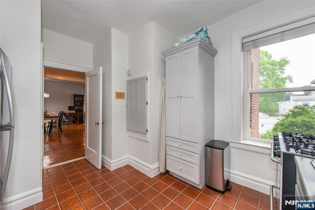 walk in closet featuring dark tile patterned flooring