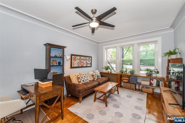 living room with crown molding, ceiling fan, and an office area