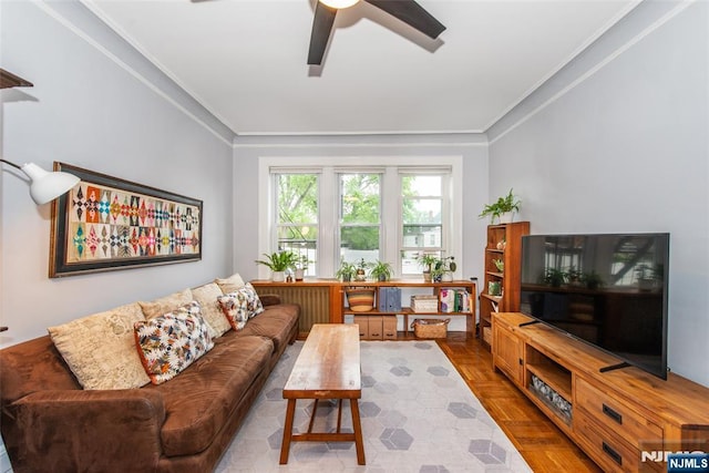 living room with ceiling fan and ornamental molding