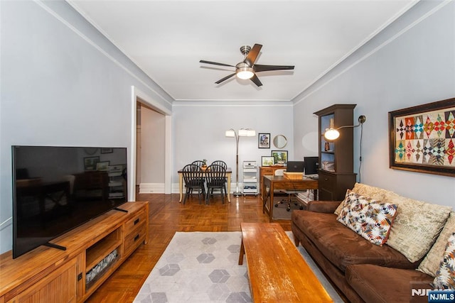 living area with a ceiling fan, a desk, and crown molding